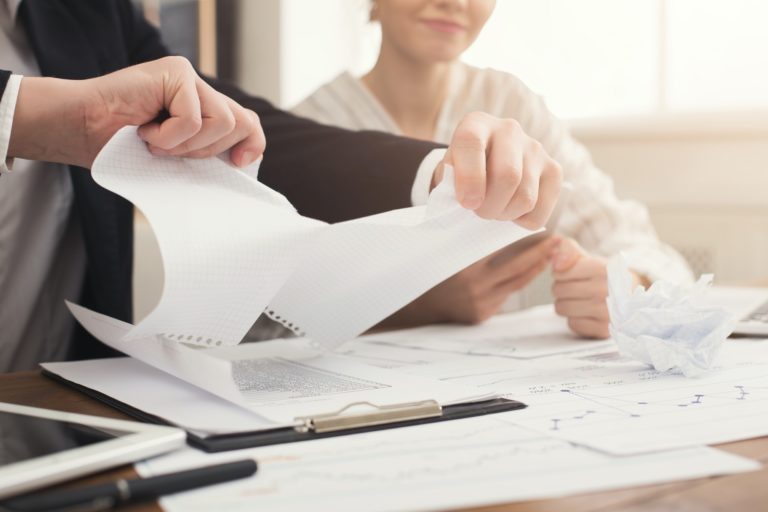 Angry businessman tearing up a document