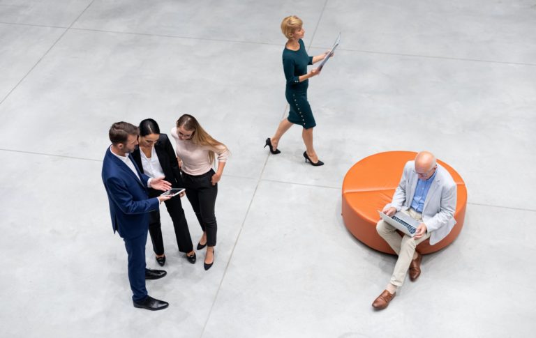 Diverse group of business people of all ages top view in modern interior