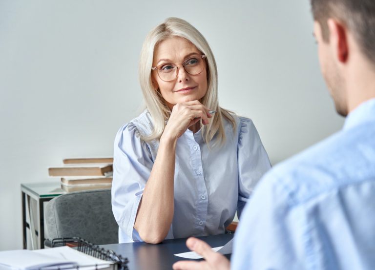 Middle aged female hr employer listening candidate at job interview.