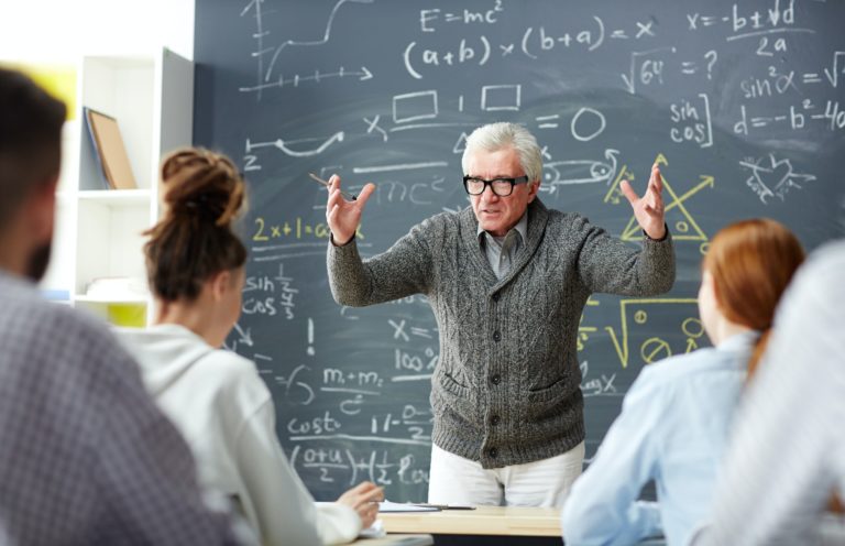 Teacher by blackboard