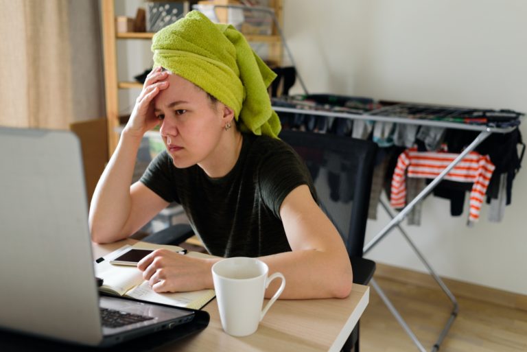 Woman working from home. Thinking, tired