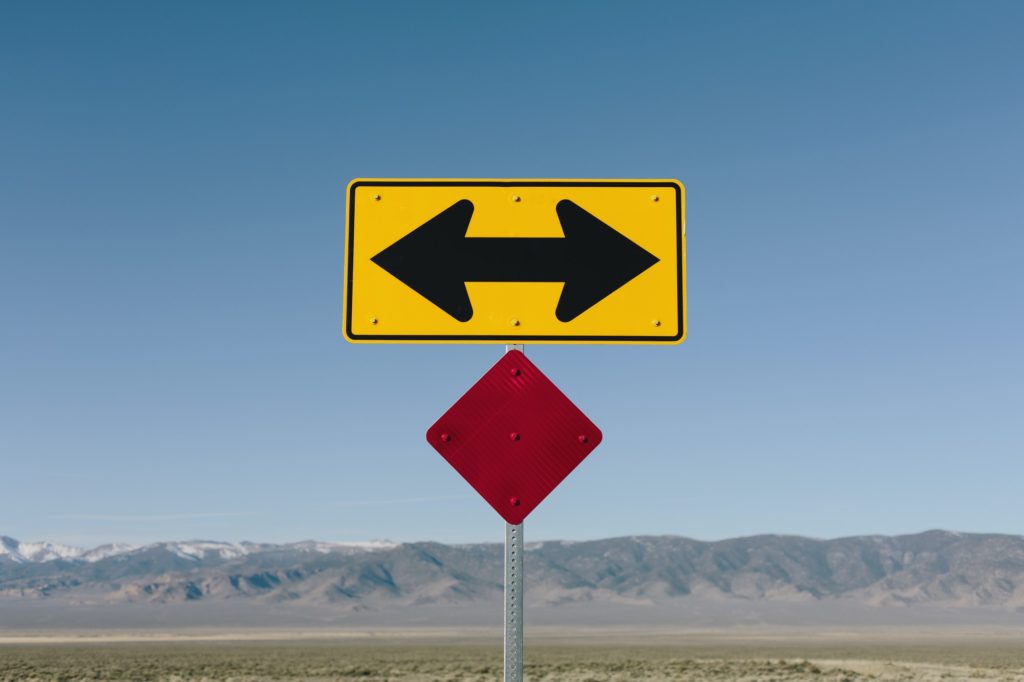 Directional arrow sign along rural road near Orvada.